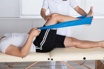 A therapist working with a patient during a physiotherapy session